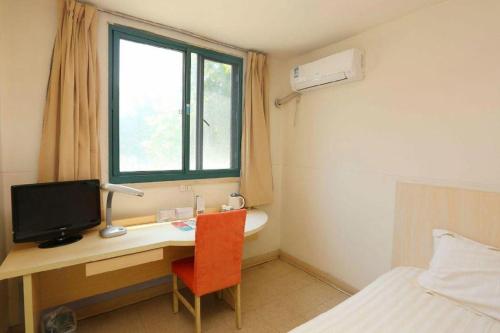 a bedroom with a desk with a computer and a bed at JinJiang Inn Nanjing The Confucius Temple Zhonghuamen Metro Station in Nanjing