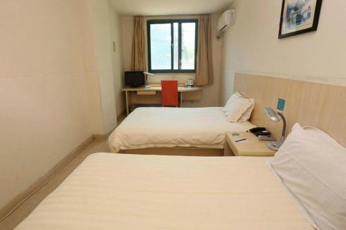 a hotel room with two beds and a desk at JinJiang Inn Nanjing The Confucius Temple Zhonghuamen Metro Station in Nanjing