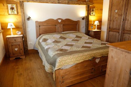 a bedroom with a bed and two night stands at Albergo Diffuso Zoncolan in Ovaro