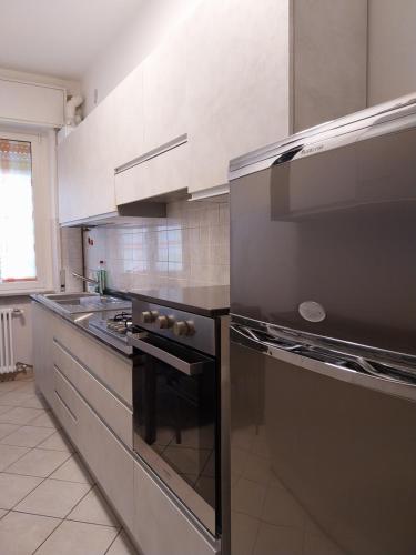 a kitchen with a stainless steel stove top oven at Residenza Cadorna in Como