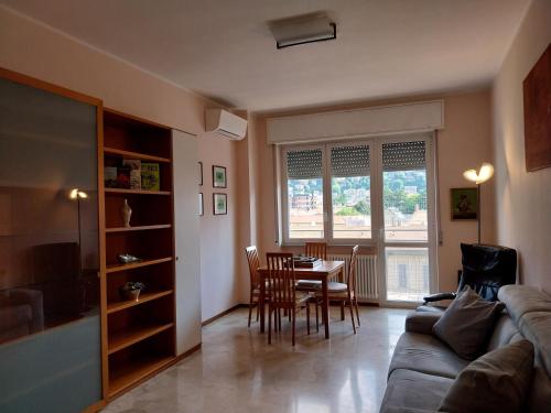 a living room with a couch and a table with chairs at Residenza Cadorna in Como