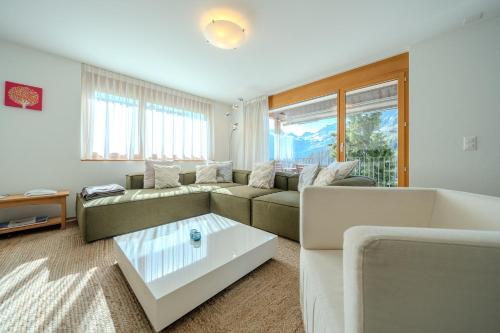 a living room with a couch and a coffee table at Sunnaschy Heidi by Arosa Vacations, Exklusive App nahe Skilift-Kulm mit Privatparkplatz in Arosa