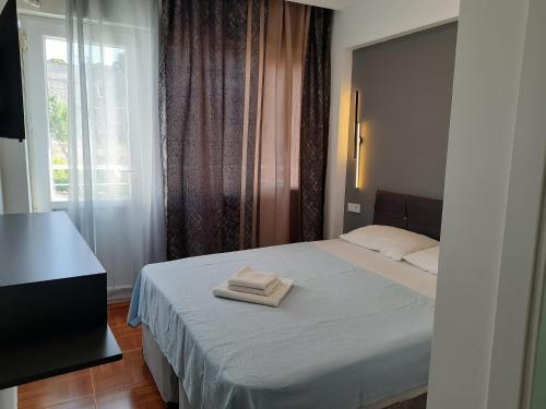 Ένα ή περισσότερα κρεβάτια σε δωμάτιο στο Hotel Ephesians