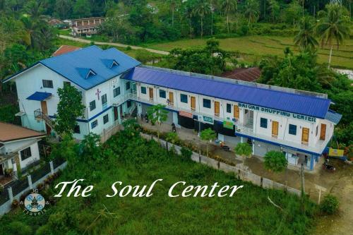 an aerial view of a house with a blue roof at The Soul Center in Batuan