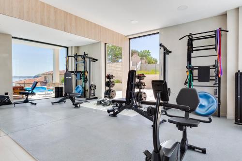 a gym with several treadmills and tread machines at Apartina - Sea view apartments in Rtina