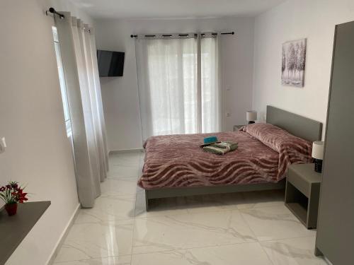 a bedroom with a bed with a red blanket at POLITIS House in Kalithies