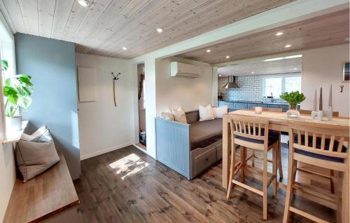 a kitchen and living room with a table and a couch at 2 Bedroom Cozy Home In Unnaryd in Sunnaryd