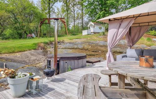 a patio with a grill and a wooden table at 4 Bedroom Cozy Home In Flo in Flo