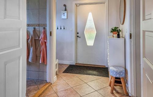 a hallway with a door and a stool next to a room at 4 Bedroom Cozy Home In Flo in Flo