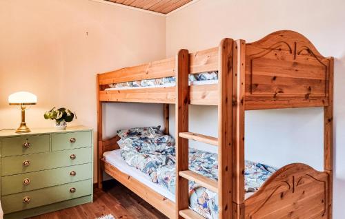 a bedroom with bunk beds and a dresser at 2 Bedroom Beautiful Home In Västerlanda in Västerlanda