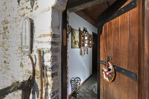 a hallway with a door and a wall with paintings at Archontiko Michael since 1868 in Vizitsa