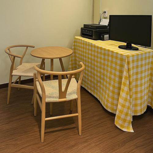 a desk with a table with a computer and chairs at Singil house in Seoul