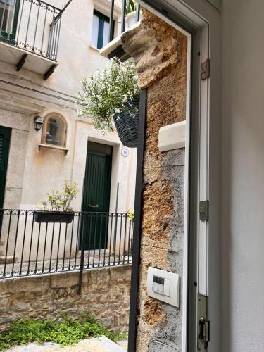 a door to a building with a balcony at Oltremare in Cefalù