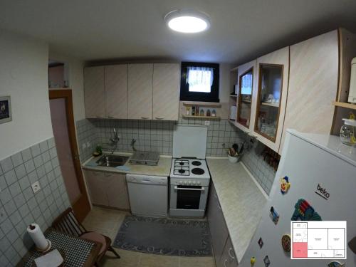 a small kitchen with a stove and a refrigerator at Ilidža Apartment in Sarajevo