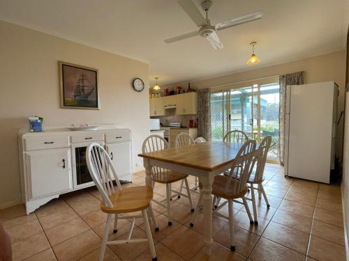 a kitchen and dining room with a table and chairs at Schoolhouse Cottage - American River in American River