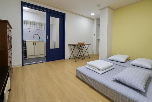 a bedroom with a bed and a table in a room at Singil house in Seoul