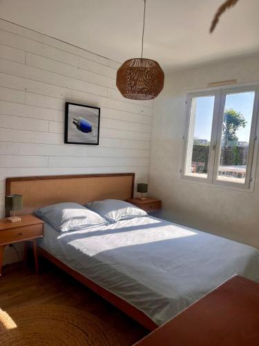 une chambre avec un lit et deux tables et une fenêtre dans l'établissement Renovated house near beaches, à Saint-Coulomb