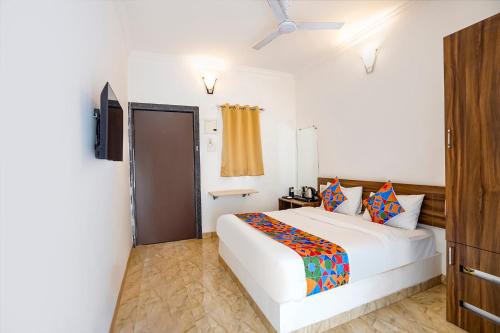 a bedroom with a white bed and a window at FabHotel Luminous Beach Resort - Nr Morjim Beach in Morjim