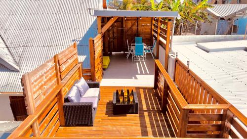 an overhead view of a deck with a table and chairs at La Kaz à Toto in Saint-Pierre