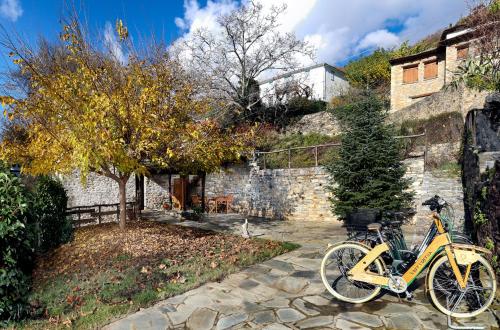a yellow bike parked in front of a building at Archontiko Michael since 1868 in Vizitsa