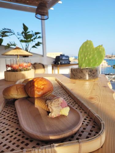 a table with a cutting board with bread and a cactus at La Terrazza sul Faro in Porto Empedocle