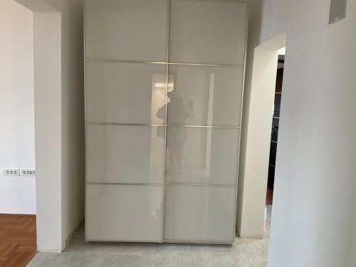 a white closet with glass shelves in a room at Vila Fjaka in Dugi Rat