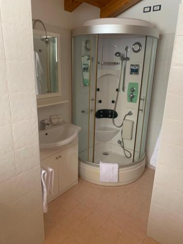 a bathroom with a shower and a sink at Relais Tesino in Castello Tesino