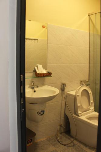 a bathroom with a toilet and a sink at Đà Lạt View in Da Lat