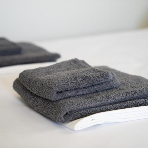 a pile of towels sitting on top of a table at ANESIS I in Livadi
