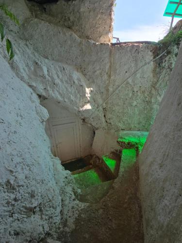 a stone staircase with a green bench in a stone wall at Kailash villa and restro in Pokhara