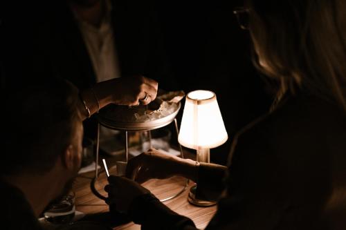 a man and a woman looking at a table with a light at Boutique Hotel Beaumont Maastricht in Maastricht