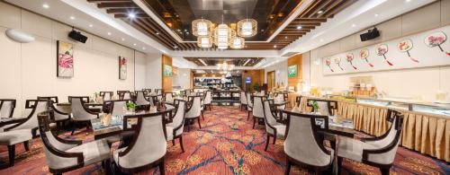 a row of tables and chairs in a restaurant at Lyhn International Hotel Chengdu Taikoo Li in Chengdu