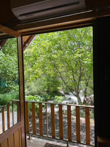 a window view of a tree from a porch at SkyView in Artabuynkʼ