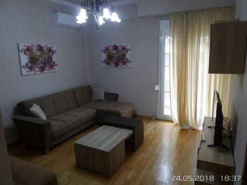 a living room with a couch and a coffee table at Kouros City Center in Kavala