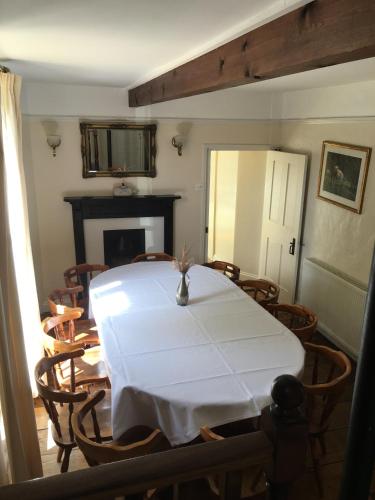 a dining room with a white table and chairs at The Crown Hotel in Mundford