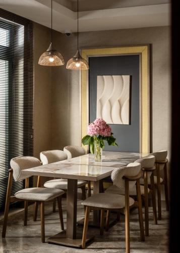 a dining room with a table and chairs at Boutique Hotel Villa Royal in Tivat
