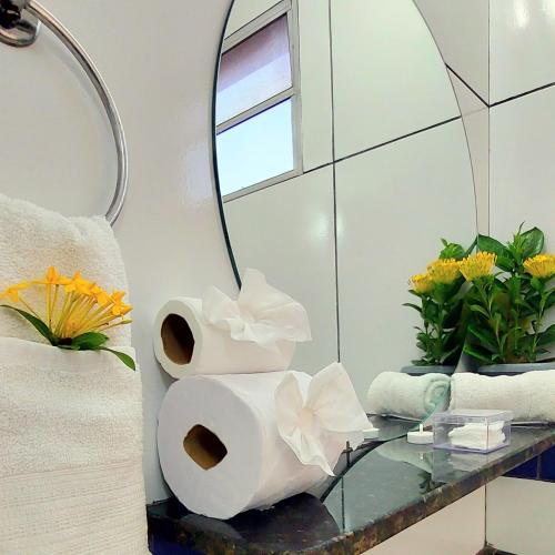 a bathroom with a mirror and a glass table at JACY AP GOSTOSO in São Miguel do Gostoso