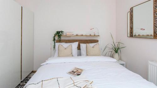 a bedroom with a bed with white sheets and pillows at Baltic Line - Sobieszewski Raj in Gdańsk