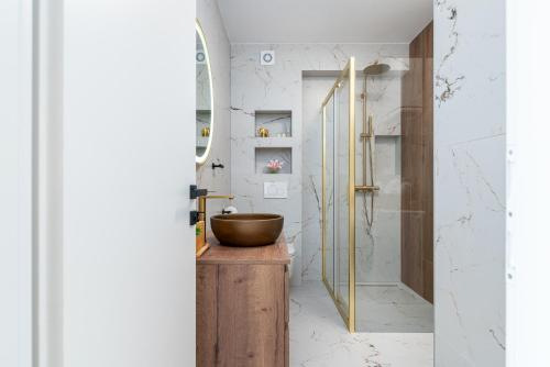 a bathroom with a wooden sink and a shower at Natura Vita Apartment-New Modern Apartment with City View & two Free Parking Spaces-10 min Walk to Trogir Old Town in Trogir