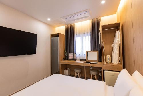 a hotel room with a bed and a desk at Giverny Hotel in Gyeongju
