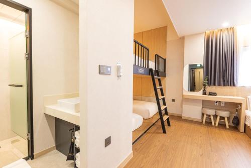 a small room with a bathroom with a sink and a ladder at Giverny Hotel in Gyeongju