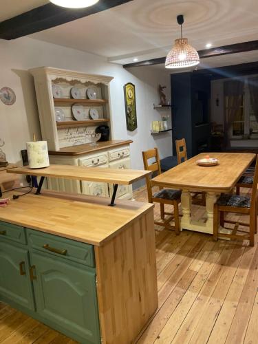 a kitchen with a table and a dining room at Les Gîtes de Monthermé Le Duplex avec vue sur la Meuse in Monthermé