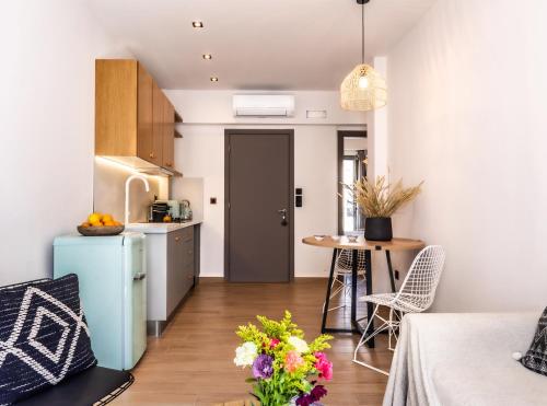 a kitchen with a blue refrigerator and a table with chairs at Sun day in Skiathos Town