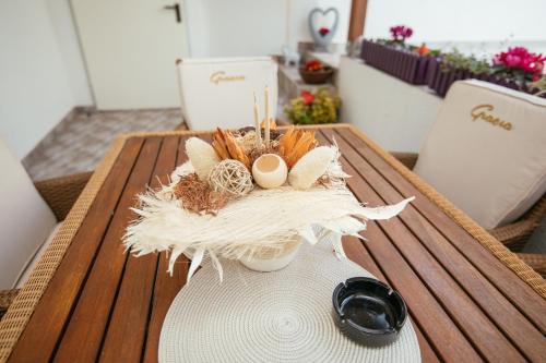 a table with eggs in a vase on it at Holiday Home Gracia in Luka