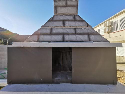 a building with a chimney on top of it at Holiday Home Gracia in Luka