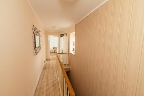 a hallway with wood paneled walls and a wooden staircase at Holiday Home Gracia in Luka