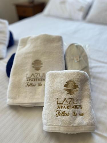 two towels sitting on top of a bed at Lazuli Zen Villa with Private Pool in Pyla