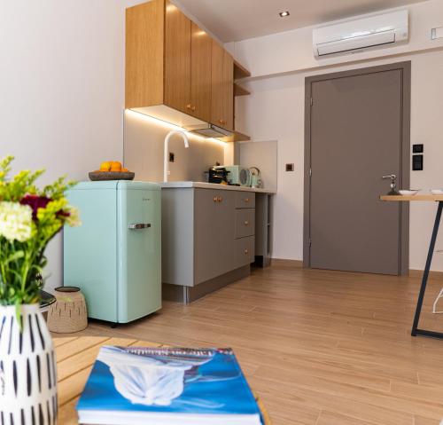 a kitchen with a refrigerator and a table in a room at Sun day in Skiathos Town