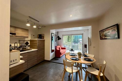 a kitchen and dining room with a table and chairs at Le Jardinet - With office in the city center! in Castelnau-le-Lez