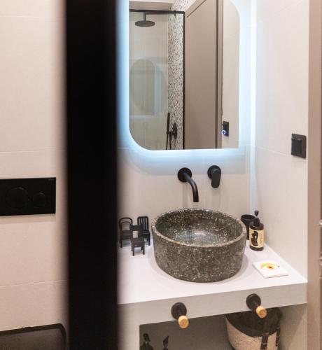 a bathroom with a sink and a mirror at Sun day in Skiathos Town